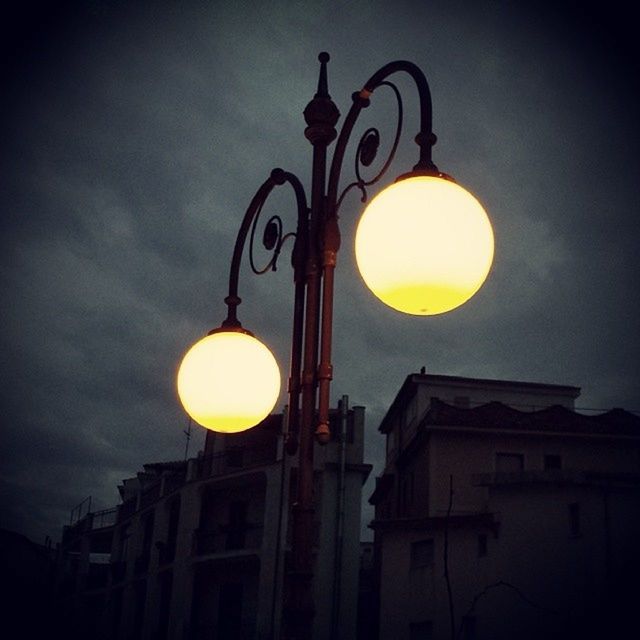 low angle view, lighting equipment, built structure, architecture, street light, sky, illuminated, building exterior, electric lamp, electric light, lantern, electricity, sunset, lamp, lamp post, moon, dusk, silhouette, no people, outdoors