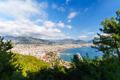 High angle view of townscape by sea against sky