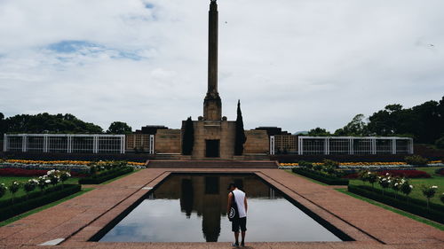 Rear view of man standing by monument