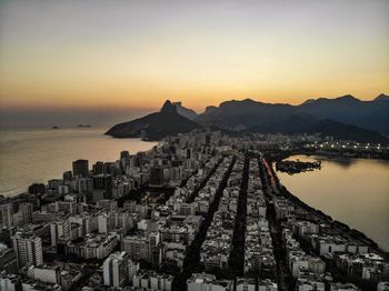 Panoramic view of city and buildings against sky at sunset