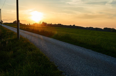 Scenic view of field against sky during sunset