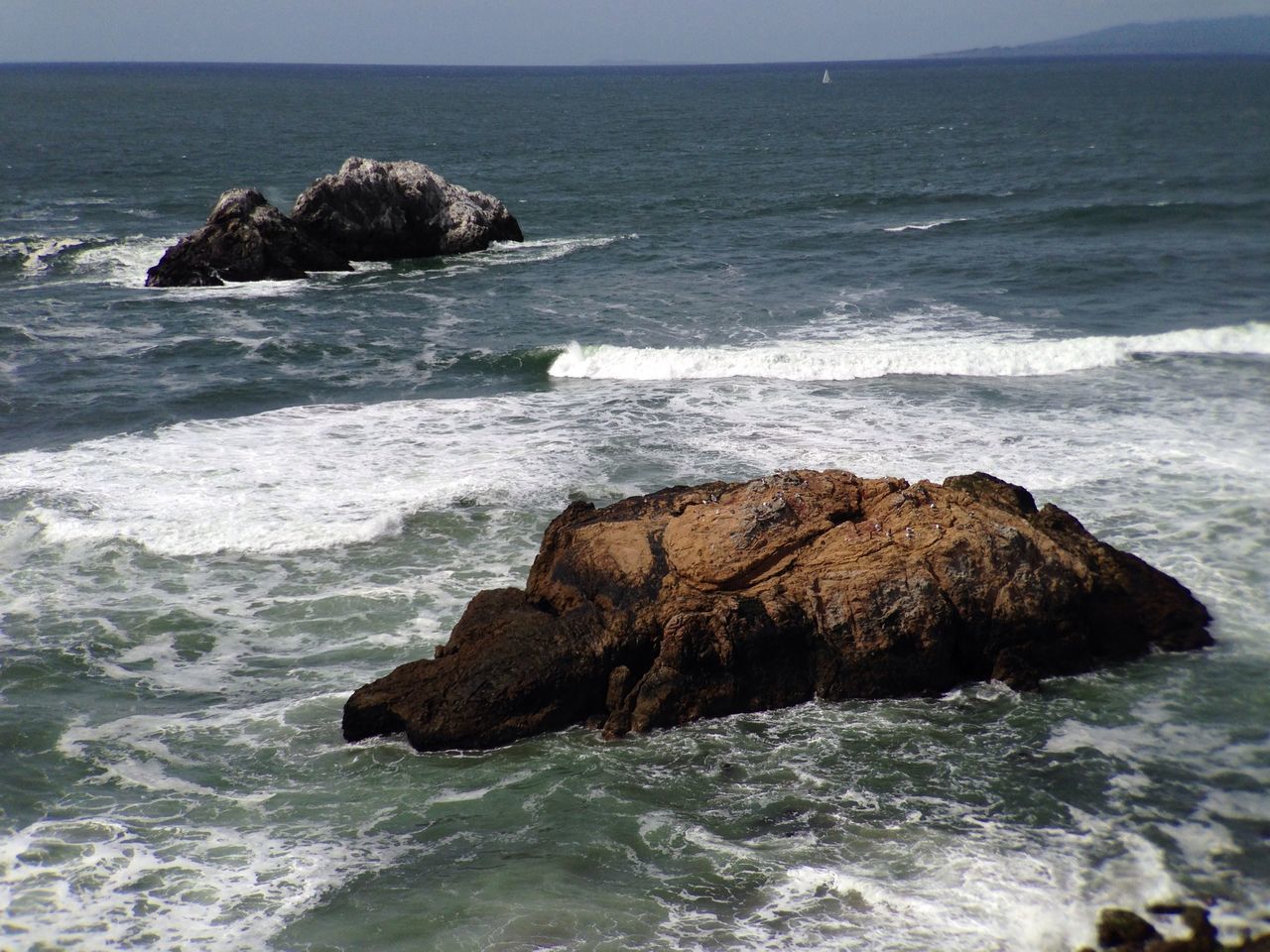 sea, water, horizon over water, rock - object, rock formation, scenics, beauty in nature, wave, rock, tranquil scene, tranquility, nature, surf, cliff, beach, shore, idyllic, sky, seascape, coastline