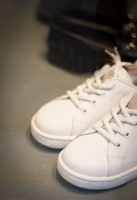 Close-up of white shoes on table