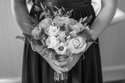 Midsection of woman holding flower bouquet