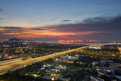 High angle view of illuminated buildings against sky at sunset