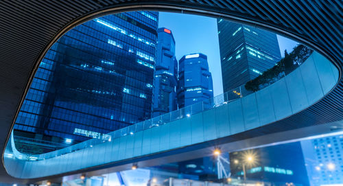 Low angle view of illuminated modern buildings in city at night