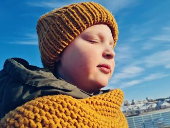 Portrait of a boy wearing yellow hat, blue sky is a background 