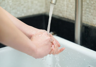 Midsection of man in bathroom at home