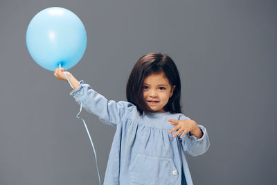 Portrait of young woman with balloons