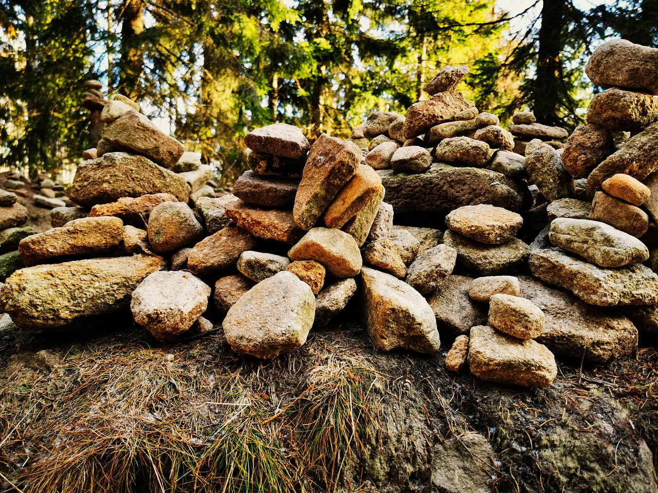 STACK OF ROCKS ON FIELD