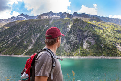 Woman looking at lake against mountain