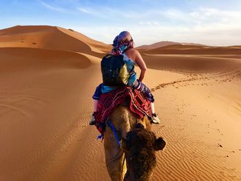 Full length of man on sand in desert against sky