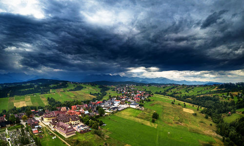 High angle view of village and houses against sky