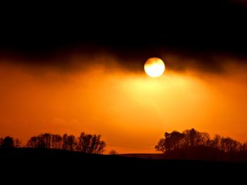 Scenic view of silhouette landscape against romantic sky at sunset