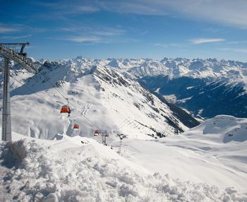 Ski lifts against snowcapped mountains