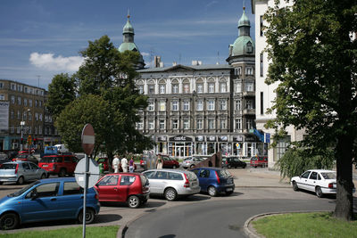 Cars on road against buildings in city