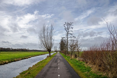 Two lane asphalt road for bicyclists and hikers in a flat polder landscape in krimpenerwaard region