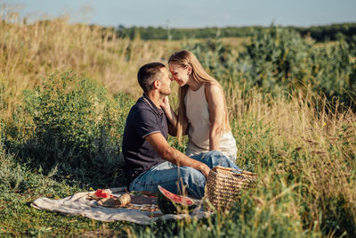 Romantic picnic. young couple in love on summer picnic with watermelon.