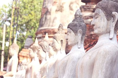 Statue of buddha against building