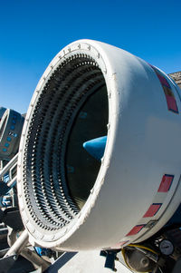 Low angle view of airplane against blue sky