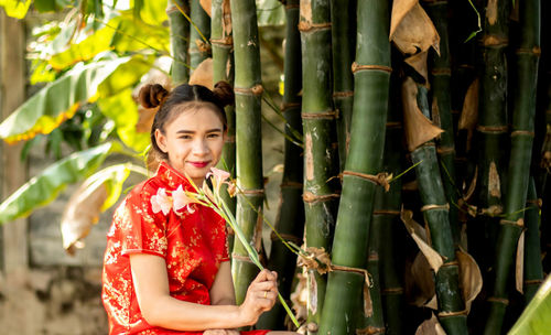 Portrait of a smiling young woman standing outdoors