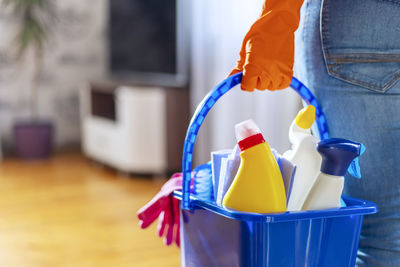 Midsection of man cleaning equipment on table