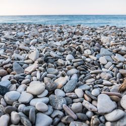 Pebbles on beach against sky