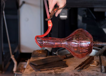 Cropped image of man making glass blower at factory