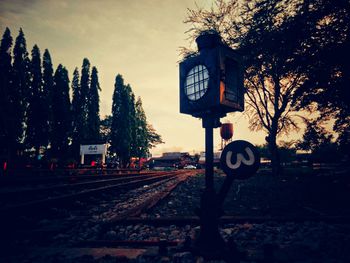 Railroad tracks by trees against sky