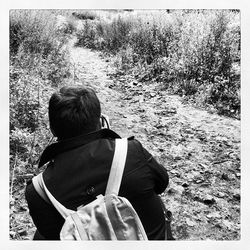 Rear view of a girl sitting on grass