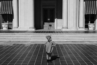 Young girl in front of building
