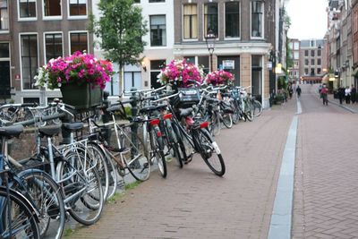 Bicycles on street amidst buildings in city
