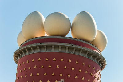 Low angle view of illuminated building against clear blue sky