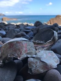 Rocks on beach against sky