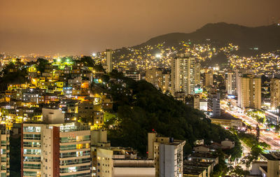 High angle view of illuminated buildings in city at night