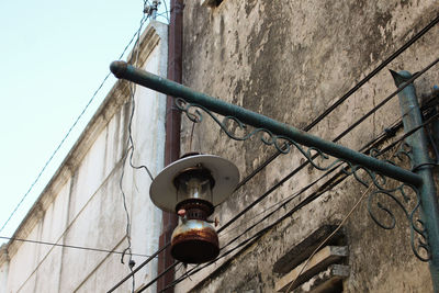 Low angle view of street light against building