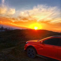 Car on road against sky during sunset