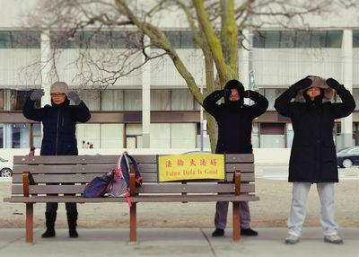 People standing against built structure