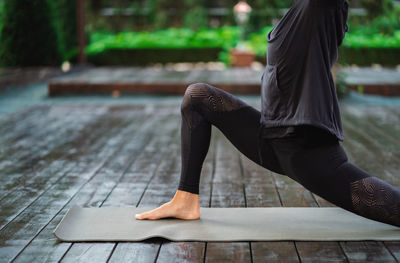 Woman exercising on mat at park