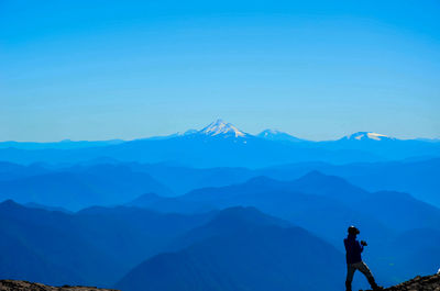 Scenic view of mountains against blue sky