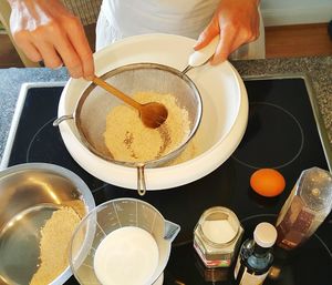 Cropped image of person preparing bread in kitchen at home