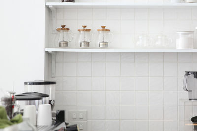 Bottles on shelf at home