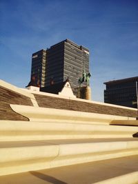 Low angle view of modern buildings against blue sky