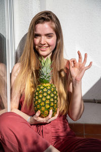 Portrait of a smiling young woman holding food