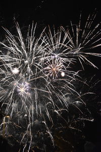 Low angle view of firework display at night