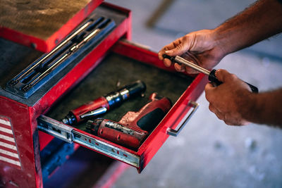 Cropped image of hands holding tools