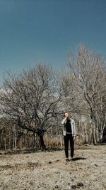 Full length of man standing on field against sky