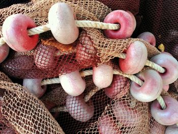 Full frame shot of fishing net with buoys at harbor