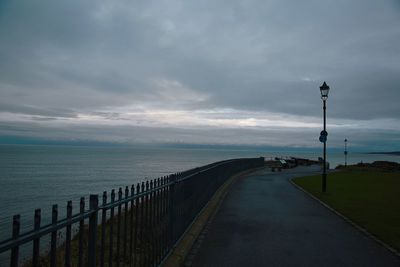 Street by sea against sky