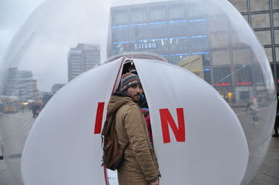 Man standing on snow covered city